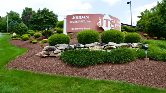 A commercial property sign for JORDAN TAX SERVICE, Inc. and JTS,